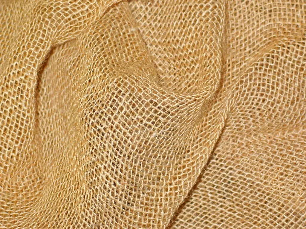 Folds of natural golden jute fabric