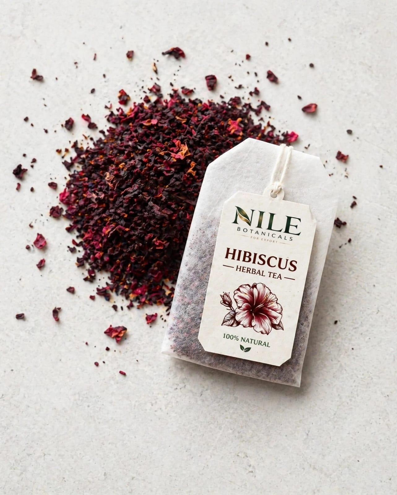 Nile hibiscus tea bag lying on loose dried hibiscus