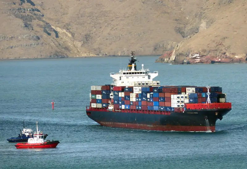 Container ship loaded with cargo leaving port